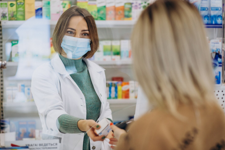 Profissional confere prescrição e organiza medicamentos em bancada de farmácia hospitalar